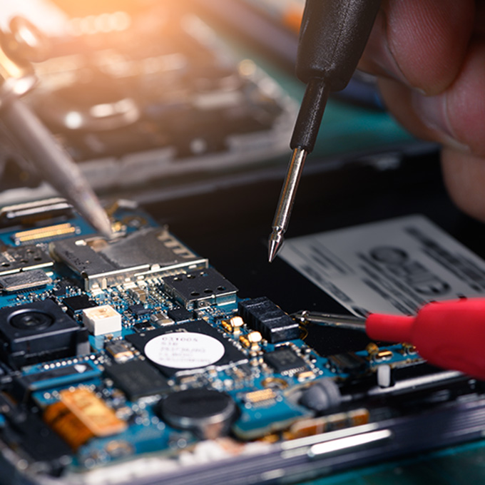 Hands working on computer circuit board